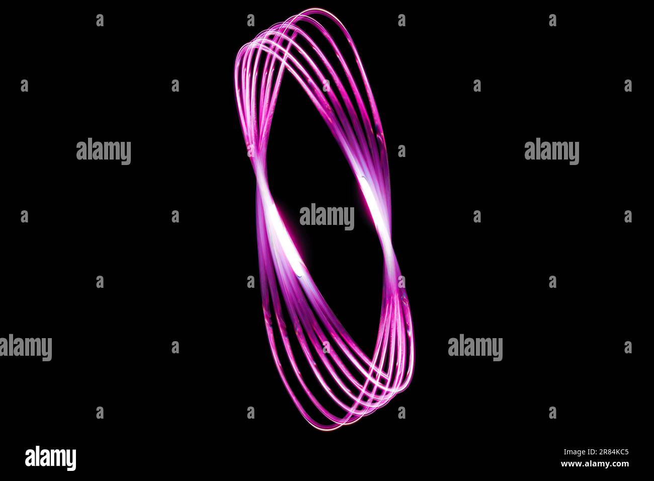 A pink swirl on a black backdrop Stock Photo