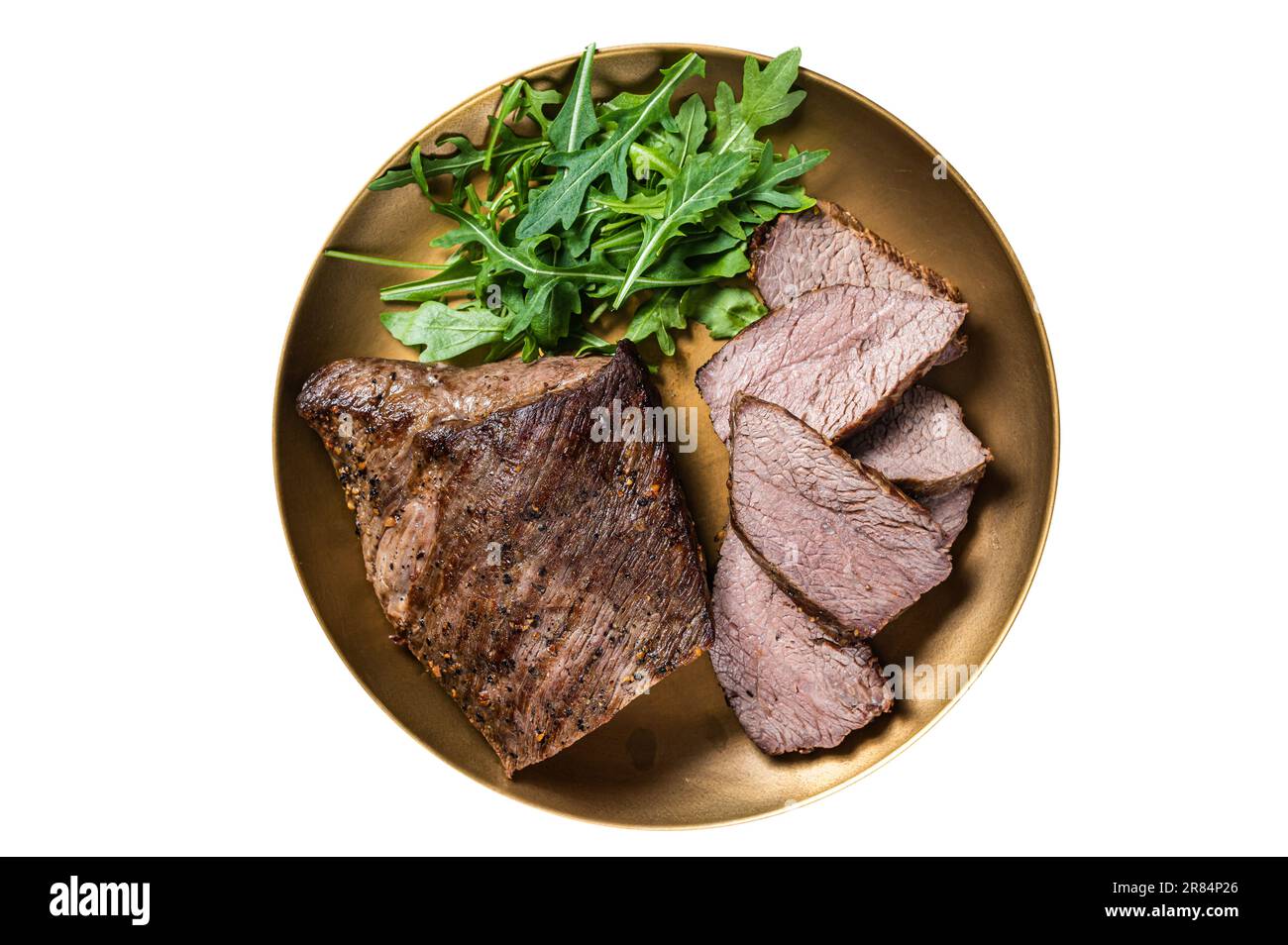 Roast Tri Tip or sirloin bottom beef steak on a plate with arugula