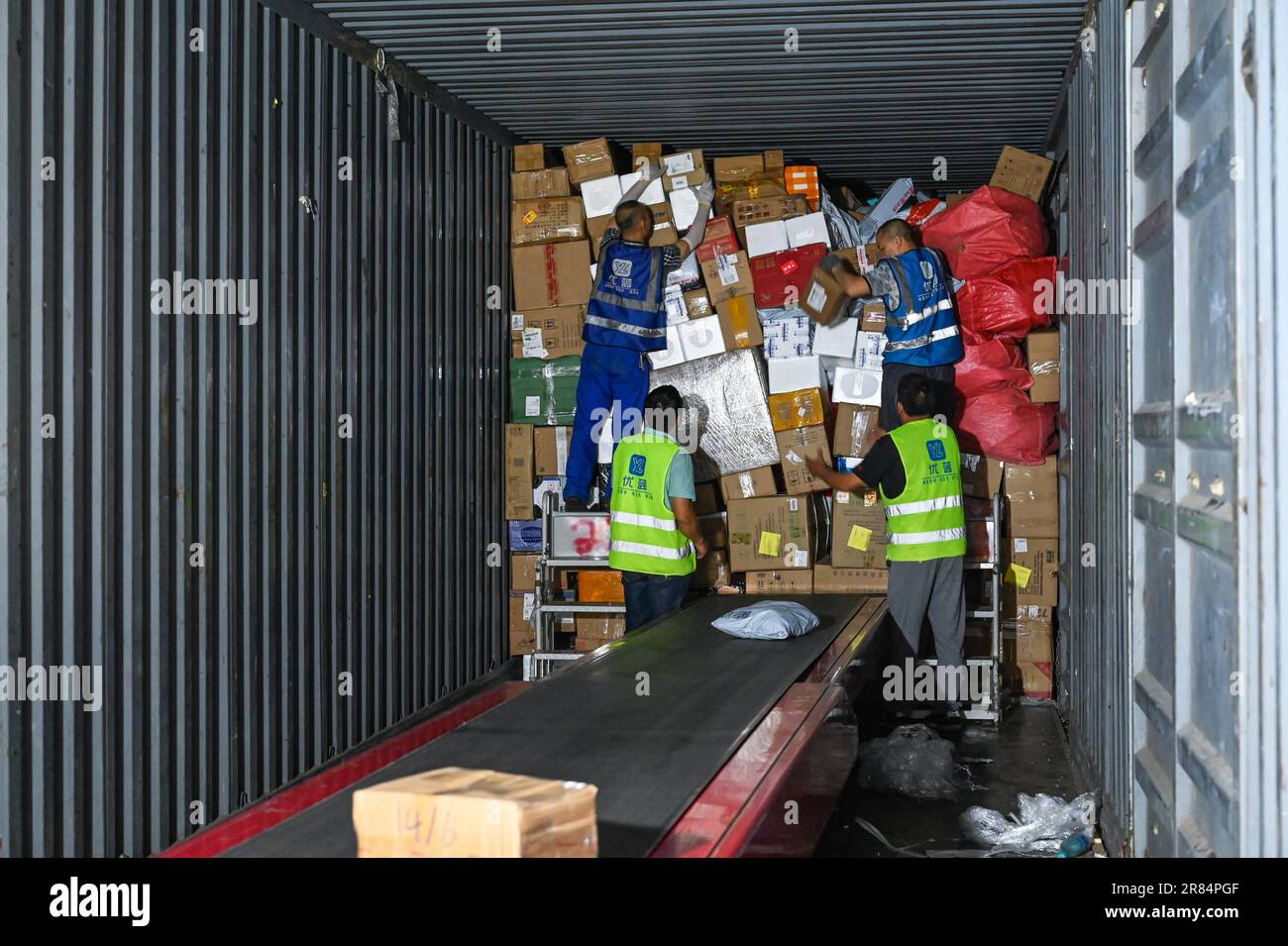 Workers sort parcels at a sorting center of JD Express in Chongqing