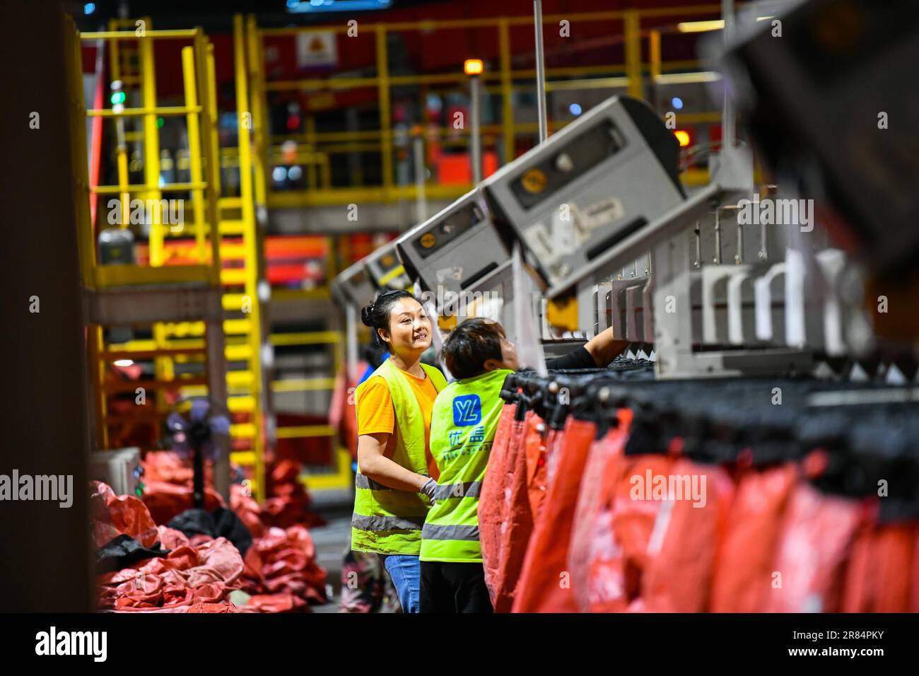 Workers sort parcels at a sorting center of JD Express in Chongqing
