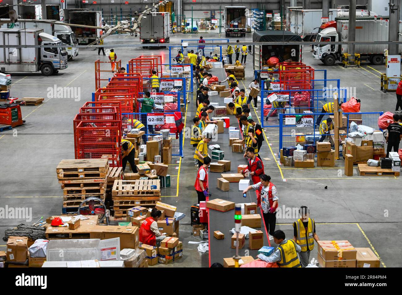 Workers sort parcels at a sorting center of JD Express in Chongqing