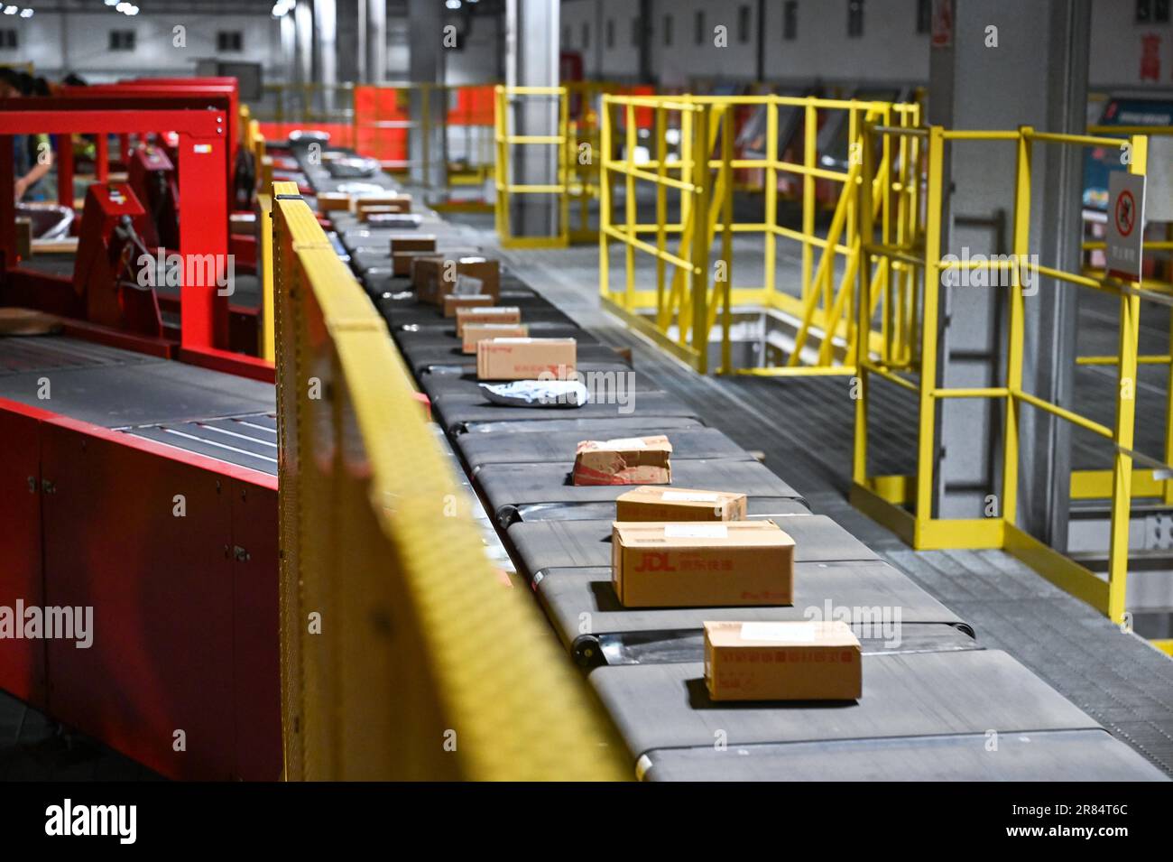 Workers sort parcels at a sorting center of JD Express in Chongqing