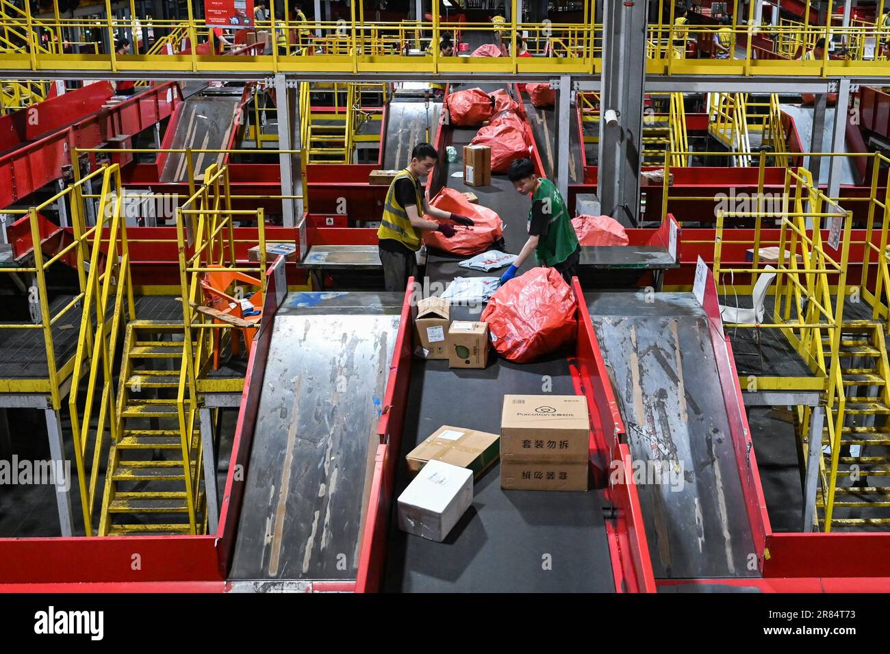 Workers sort parcels at a sorting center of JD Express in Chongqing