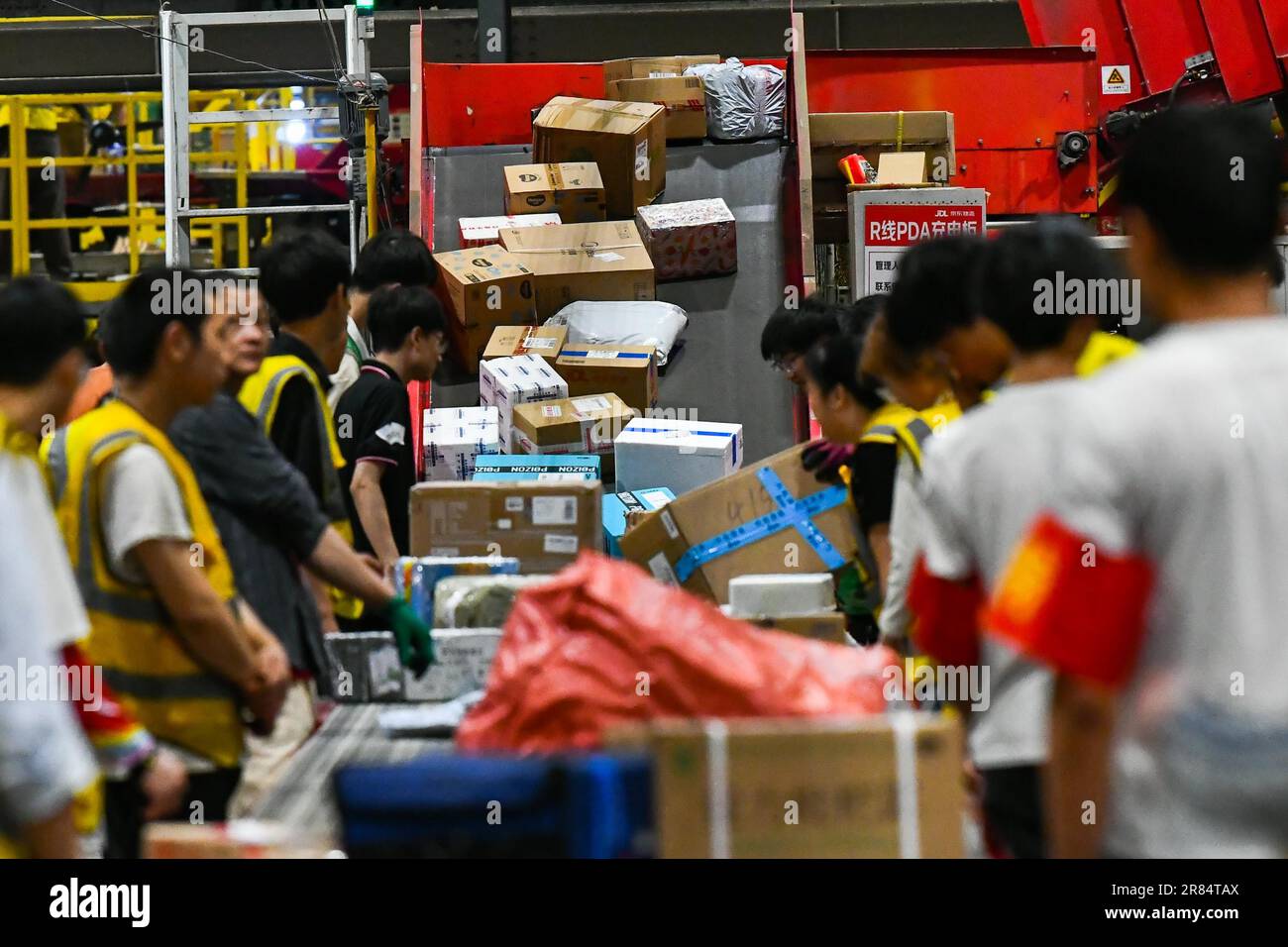 Workers sort parcels at a sorting center of JD Express in Chongqing