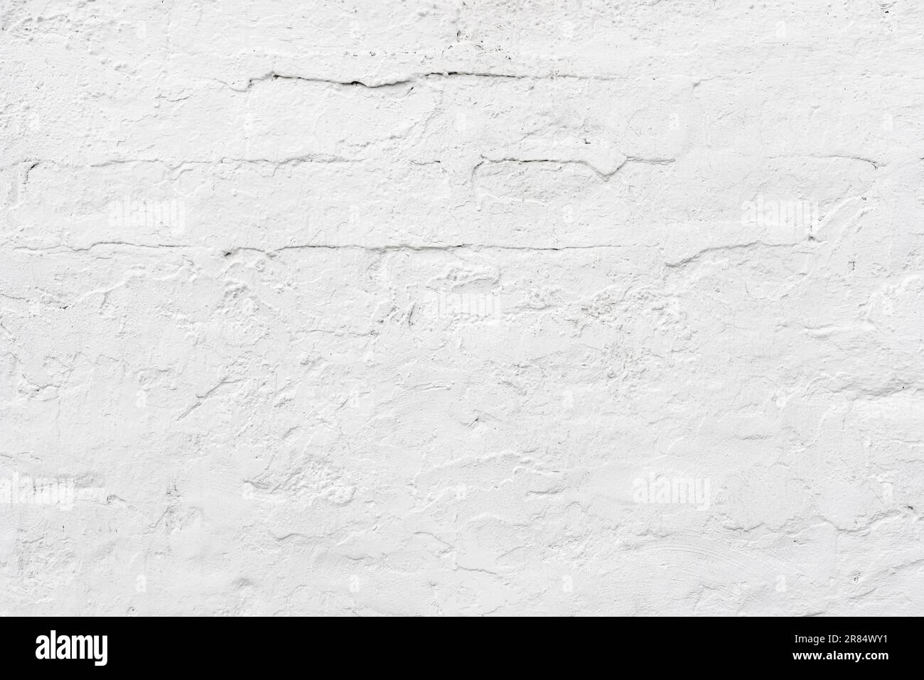 Old plaster wall painted in white with brick pattern as background