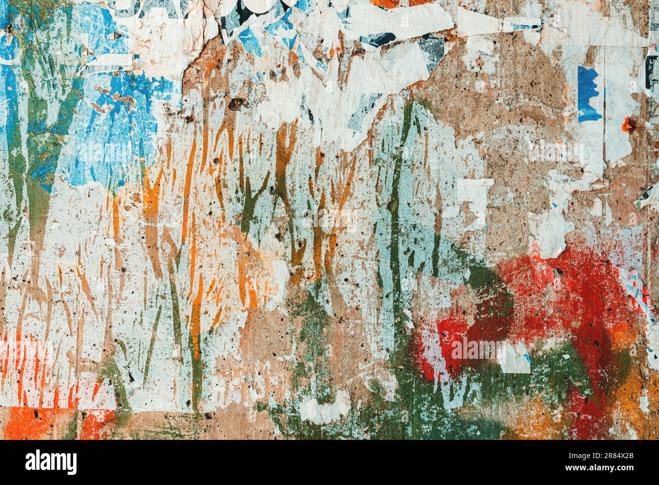 Textured surface of torn poster paper on concrete wall as grunge texture and background. Messy and grimy pattern. Stock Photo