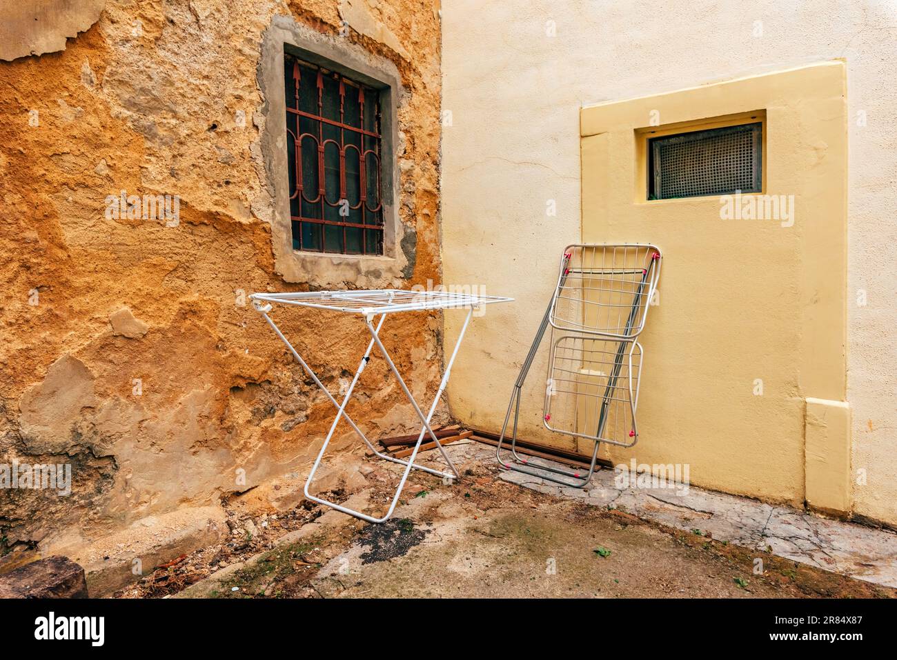 Clothes drying rack in back yard, next to the old house wall Stock