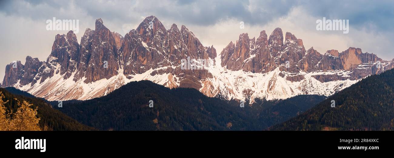 A wide 3:1 panoramic image of the Geisler / Odle mountain peaks in Val di Funes, in the Italian province of South Tyrol in the Dolomite Mountains, loc Stock Photo