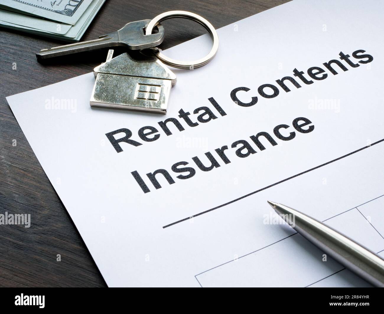 Rental contents insurance application form and key. Stock Photo