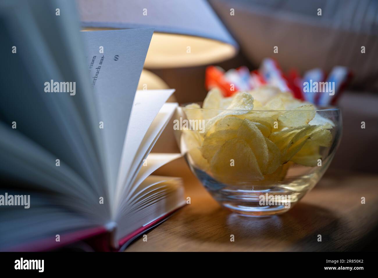 PRODUCTION - 16 June 2023, Saxony, Leipzig: ILLUSTRATION - Chips and candy bars are on a nightstand. Photo: Hendrik Schmidt/dpa Stock Photo