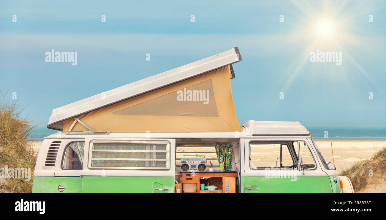 Side view of a vintage mobile home in front of a Dutch beach on the island of Ameland Stock Photo