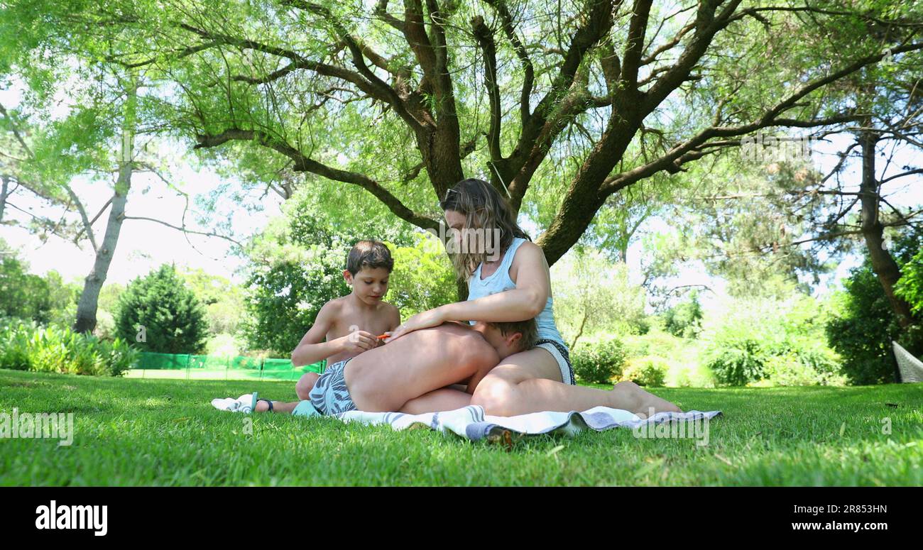 Two boy brothers fighting each other, mother separating siblings quarrel. Children dispute Stock Photo