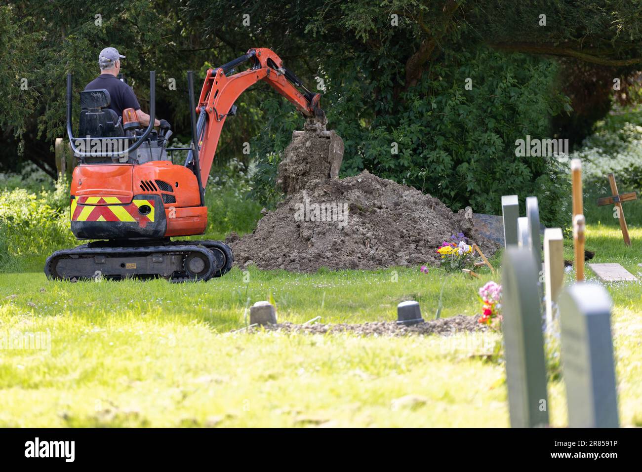 Man Digging Grave In Churchyard Ready For Funeral Small With Automated