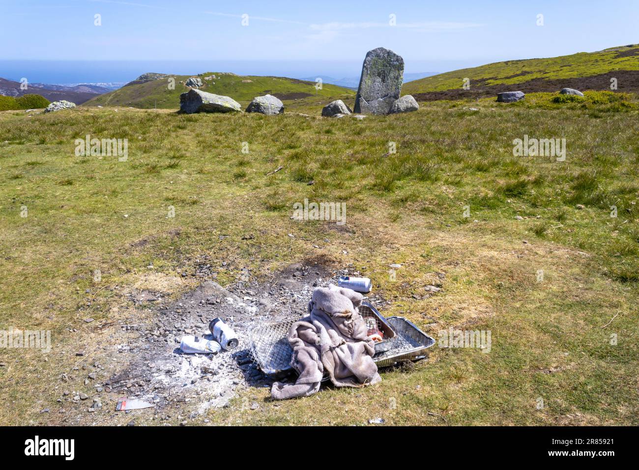 Barbeque litter at The Druid's Circle, or Meini Hirion in Welsh, above the village of Penmaenmawr, Gwynedd, Wales, UK. Stock Photo