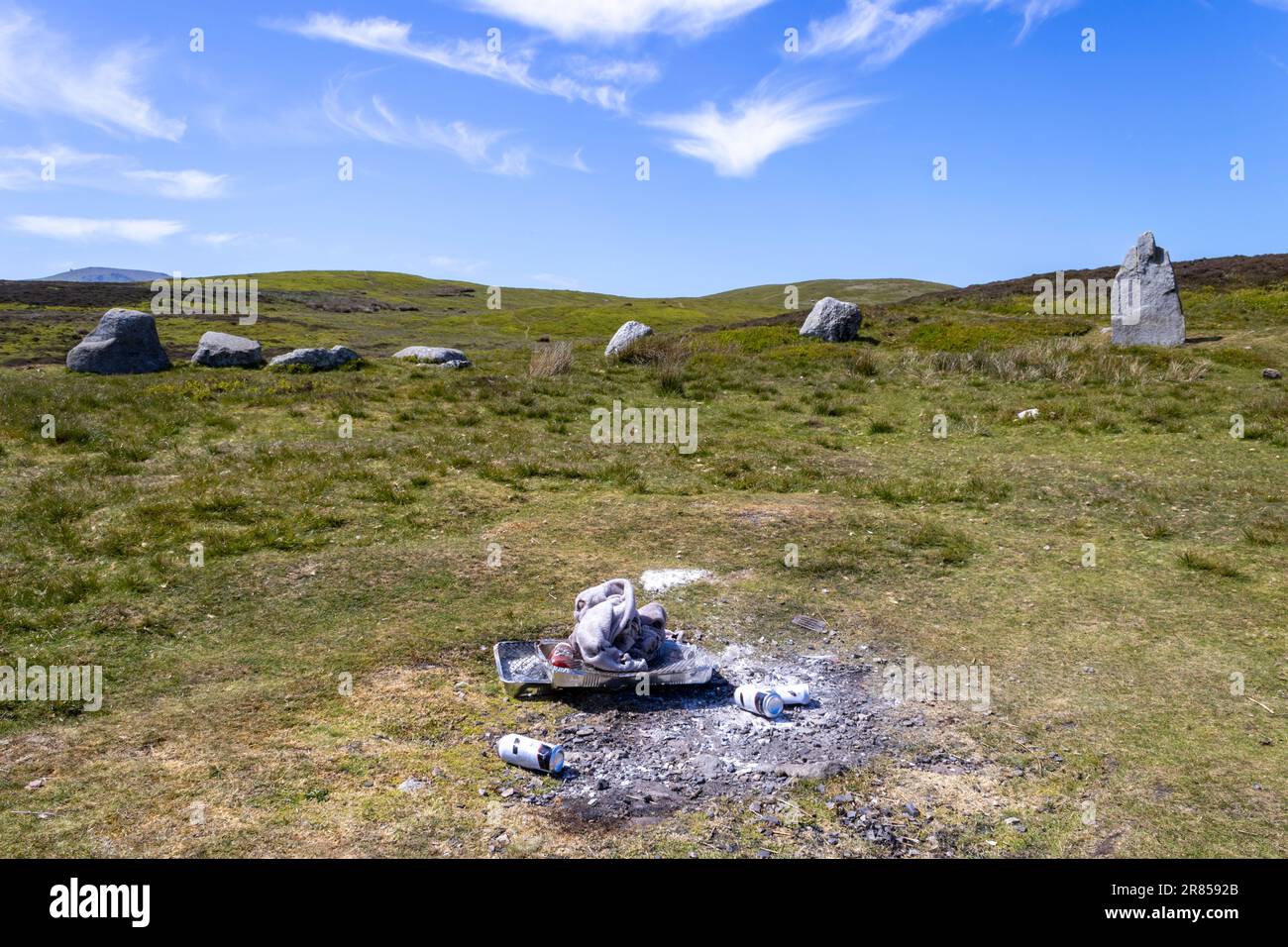 Barbeque litter at The Druid's Circle, or Meini Hirion in Welsh, above the village of Penmaenmawr, Gwynedd, Wales, UK. Stock Photo