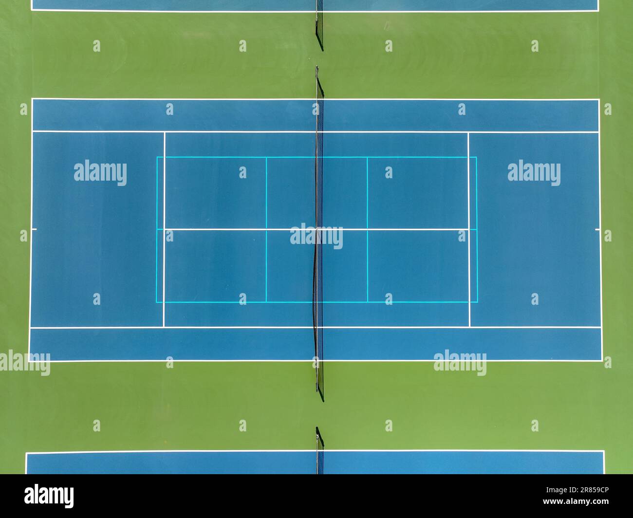 Aerial photo of blue tennis courts with white lines and light blue