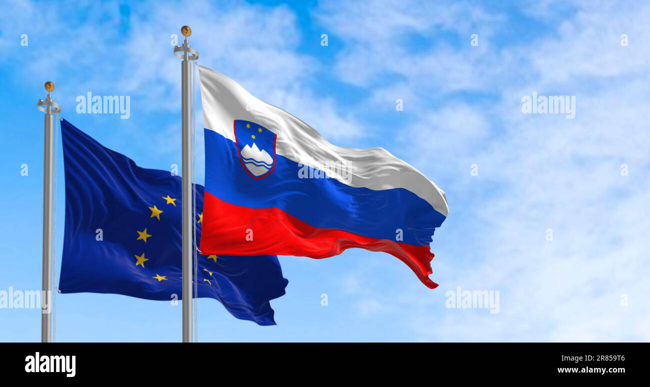 The flags of Slovenia and the European Union waving in the wind on a clear day. European Union member since 2004. 3d Illustration render. Fluttering f Stock Photo