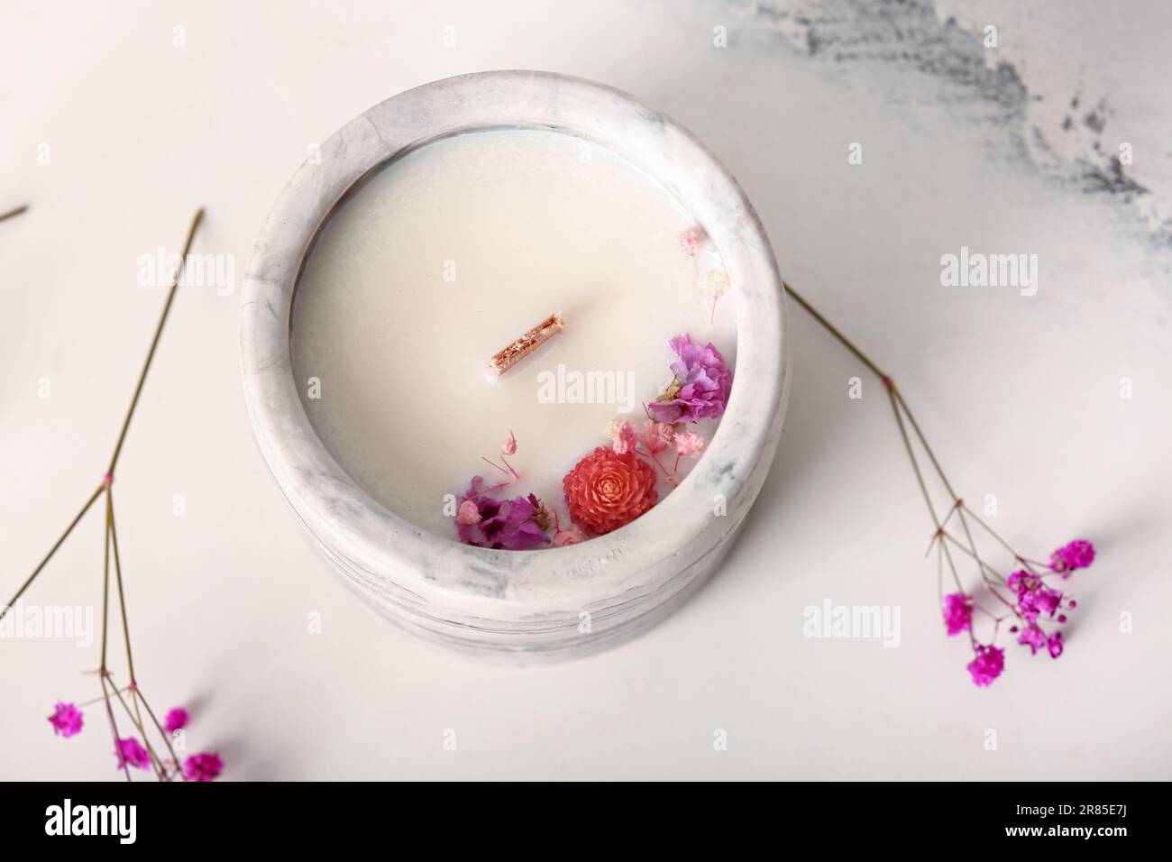 Holder with candle and flowers on white background Stock Photo - Alamy