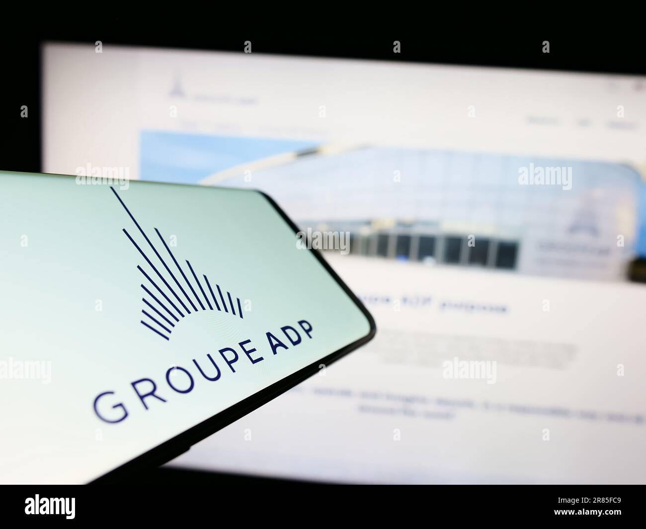 Smartphone with logo of French airport operator company Groupe ADP on screen in front of business website. Focus on center of phone display. Stock Photo