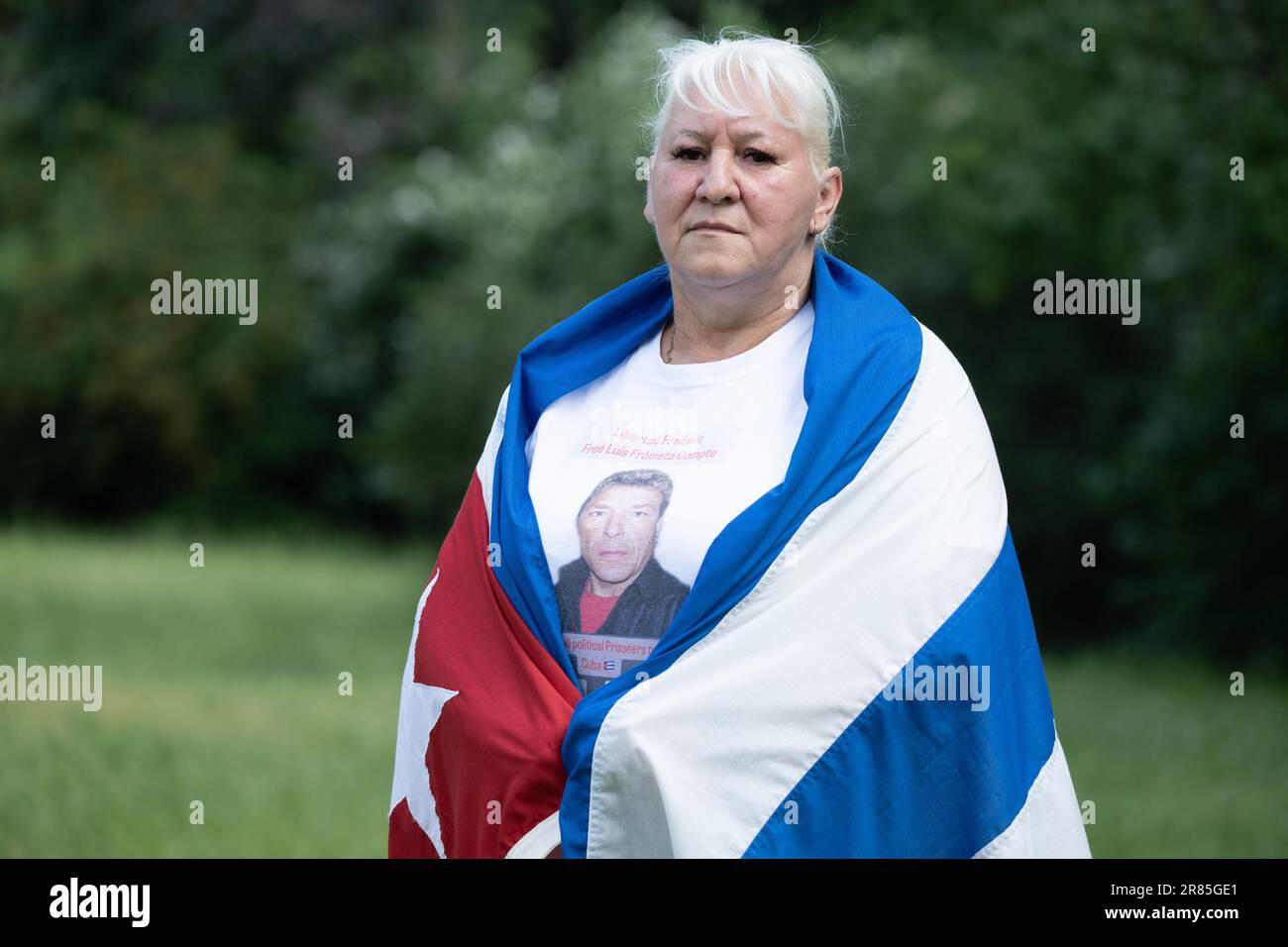 Dresden, Germany. 11th June, 2023. Silke Frometa Compte, wife of imprisoned German-Cuban Luis Frometa Compte, stands on the sidelines of a rally in Alaunpark. Frómeta Compte, from Dresden, had been on a family visit to Havana in July 2021, when demonstrations for freedom and against mismanagement broke out in many cities of the socialist Caribbean state. Frómeta Compte was arrested for filming one of the protests with a cell phone, according to his family. He was convicted of sedition, and an original 25-year sentence was reduced to 15 years. Credit: Sebastian Kahnert/dpa/Alamy Live News Stock Photo