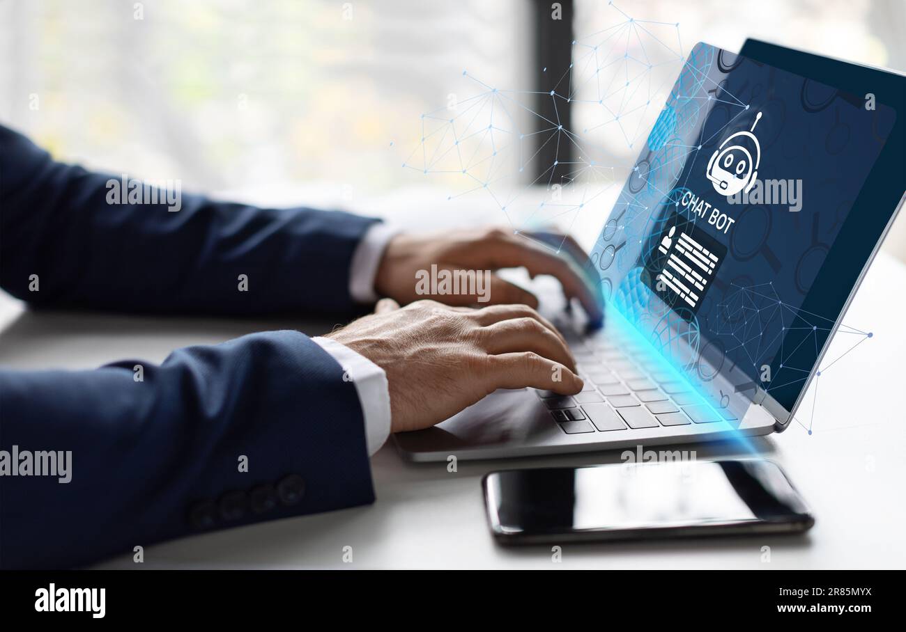 Unrecognizable businessman typing on laptop keyboard, using chatbot Stock Photo