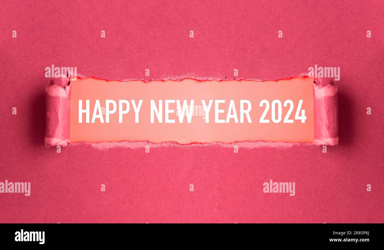 New year concept. Torn pink cardboard that reads 'Happy New Year 2024' Stock Photo
