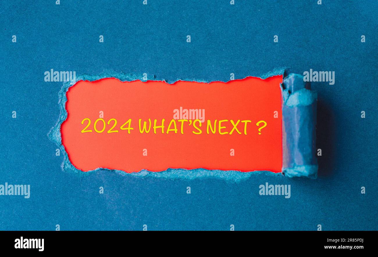 Lettering 2024 what's next? Year 2024 in a torn piece of cardboard. Enter the new year. Stock Photo