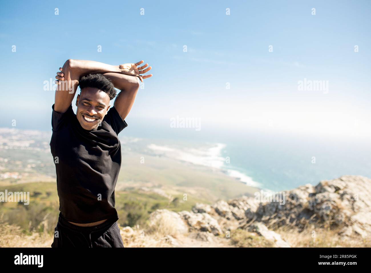 Young man stretching arm sunrise hi-res stock photography and images ...