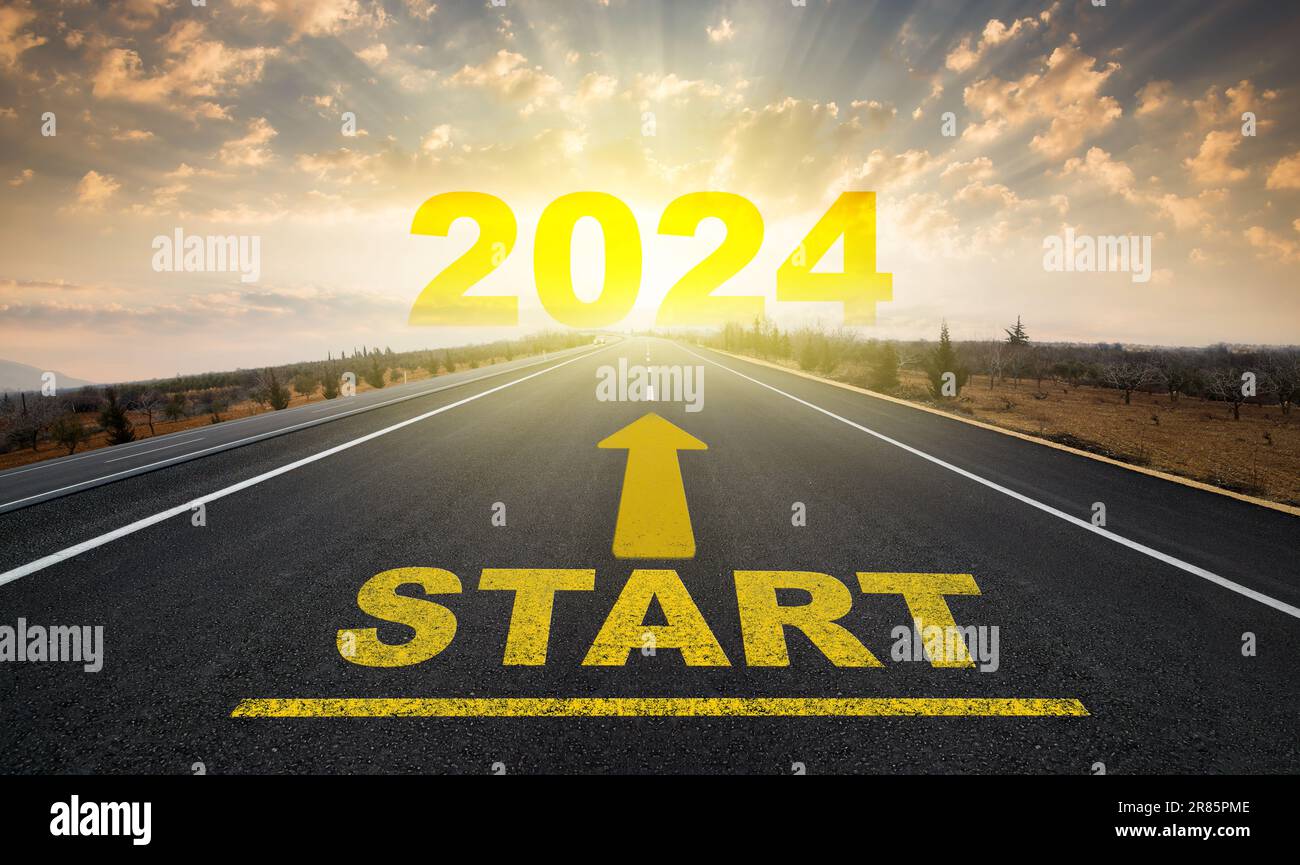 Starting the new year. Start line on asphalt road and 2024 going arrow