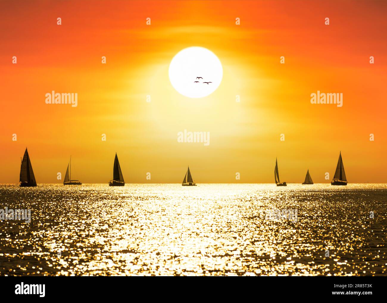 Silhouette view of sailboats at sunset. holiday background Stock Photo