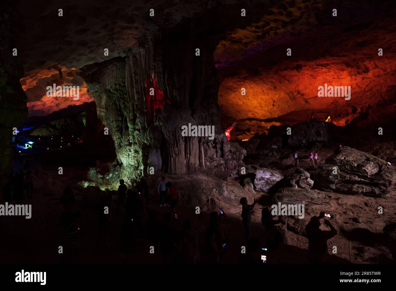Halong Bay, Vietnam. 27 April,2017. Hang Sung Sot Grotto (Cave of Surprises), suliet tourists taking photos. Stock Photo