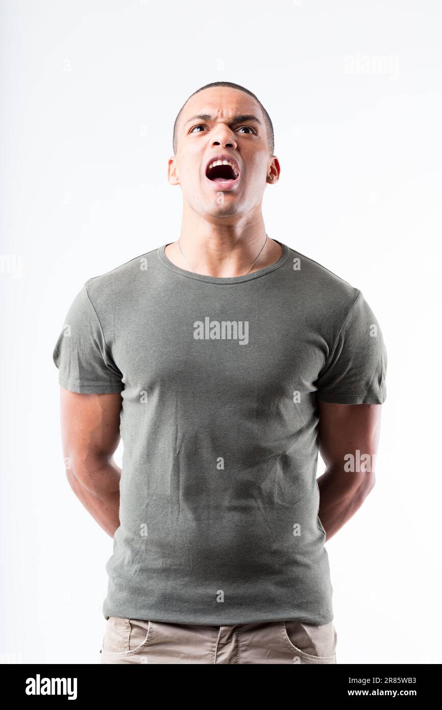 Man stands erect in a military stance, yelling an affirmative response