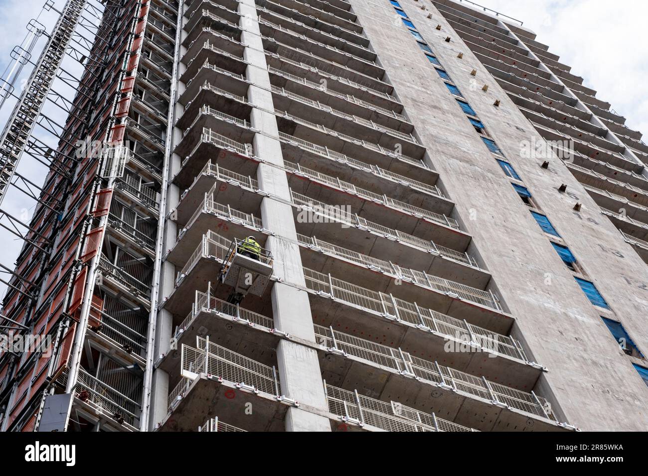 New residential apartment buildings under construction as part of development / redevelopment in the city centre as new high rise blocks rise with the floor level numbers visible on the exterior of the lift shaft on 18th May 2023 in Birmingham, United Kingdom. The city is under a long term and major redevelopment, with much of its industrial past being demolished and made into new flats for residential homes. Stock Photo