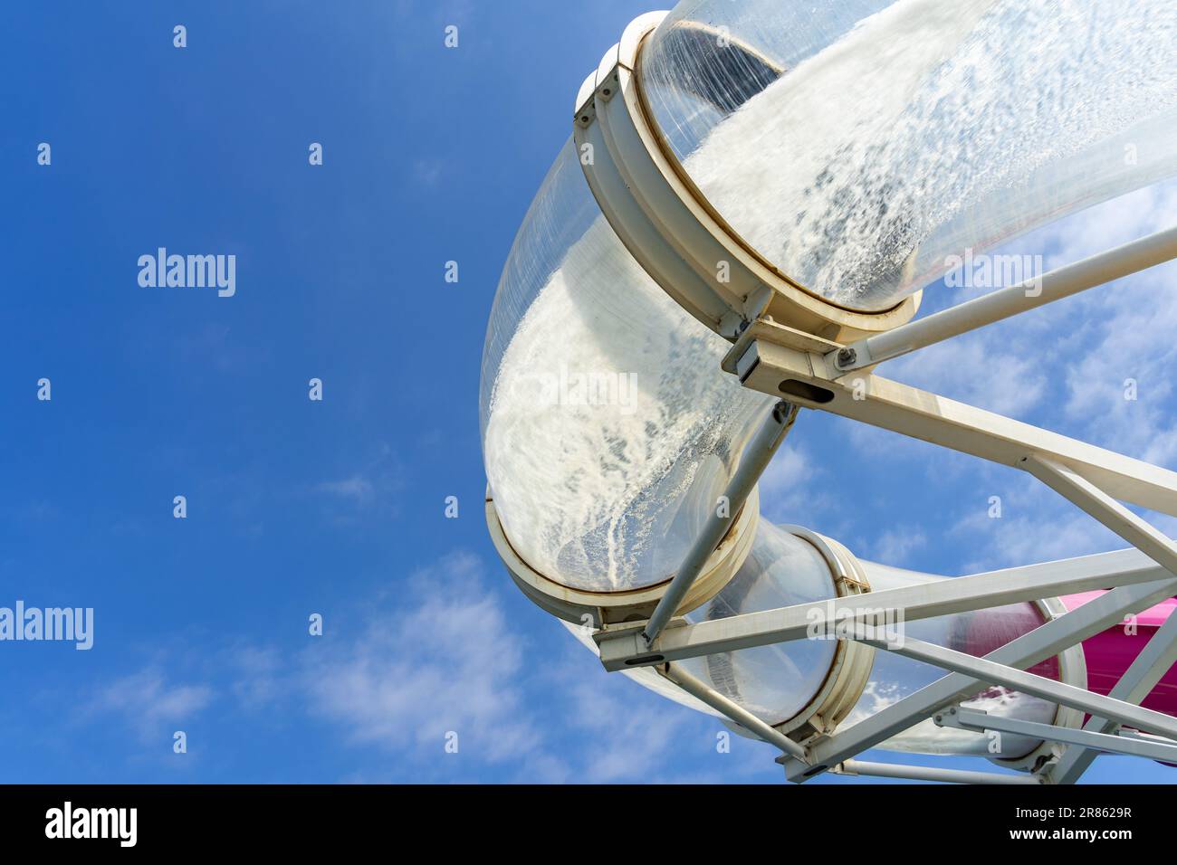 Curved part of a water slide with rushing water at a water park Stock