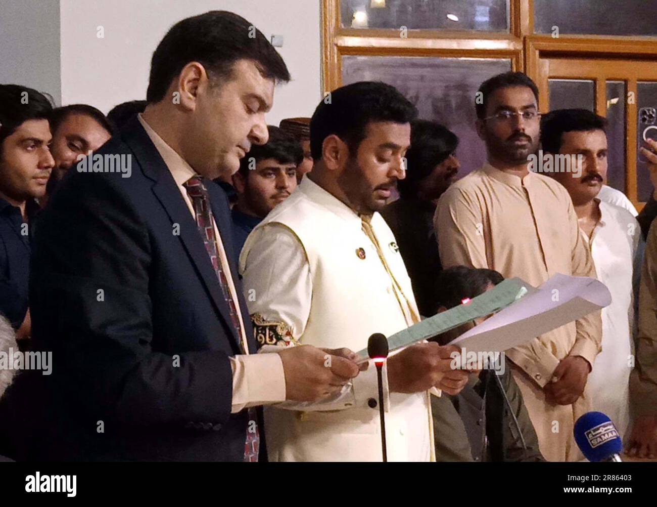 Divisional Commissioner, Bilal Ahmed Memon administrates oath of newly elected Mayor, Kashif Ali Shoro and Deputy Mayor, Saghir Ahmed Qureshi during oath taking ceremony held in Hyderabad on Monday, June 19, 2023. Stock Photo