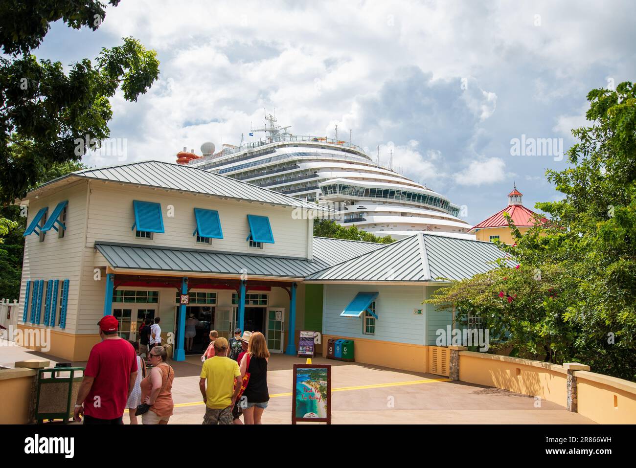 A diverse group of people enjoying a sunny day at the Carnival Vista cruise port in Roatan, Honduras Stock Photo