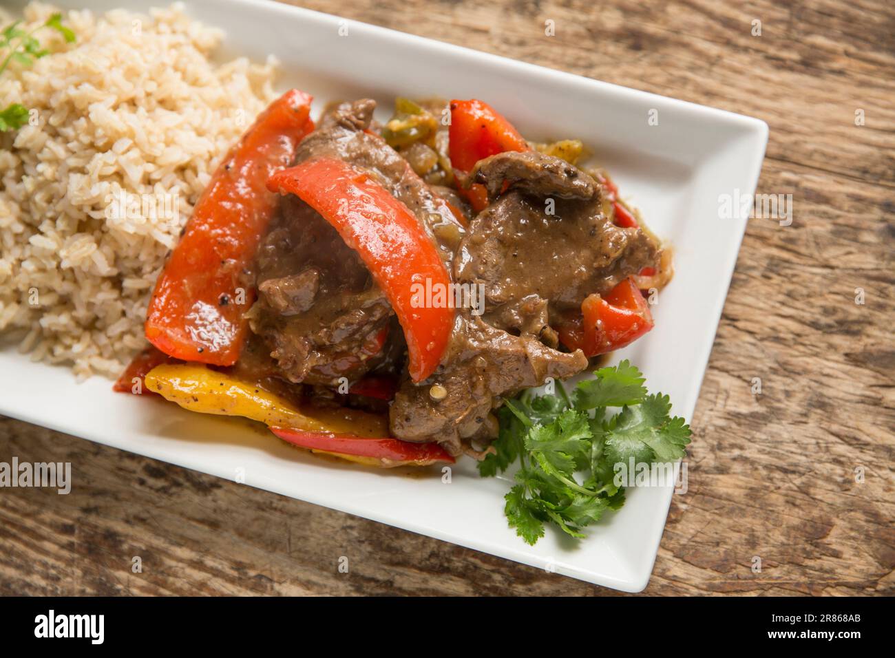 Slices of venison from a roe deer, Capreolus capreolus, that have been cooked with peppers in black bean sauce. England UK GB Stock Photo