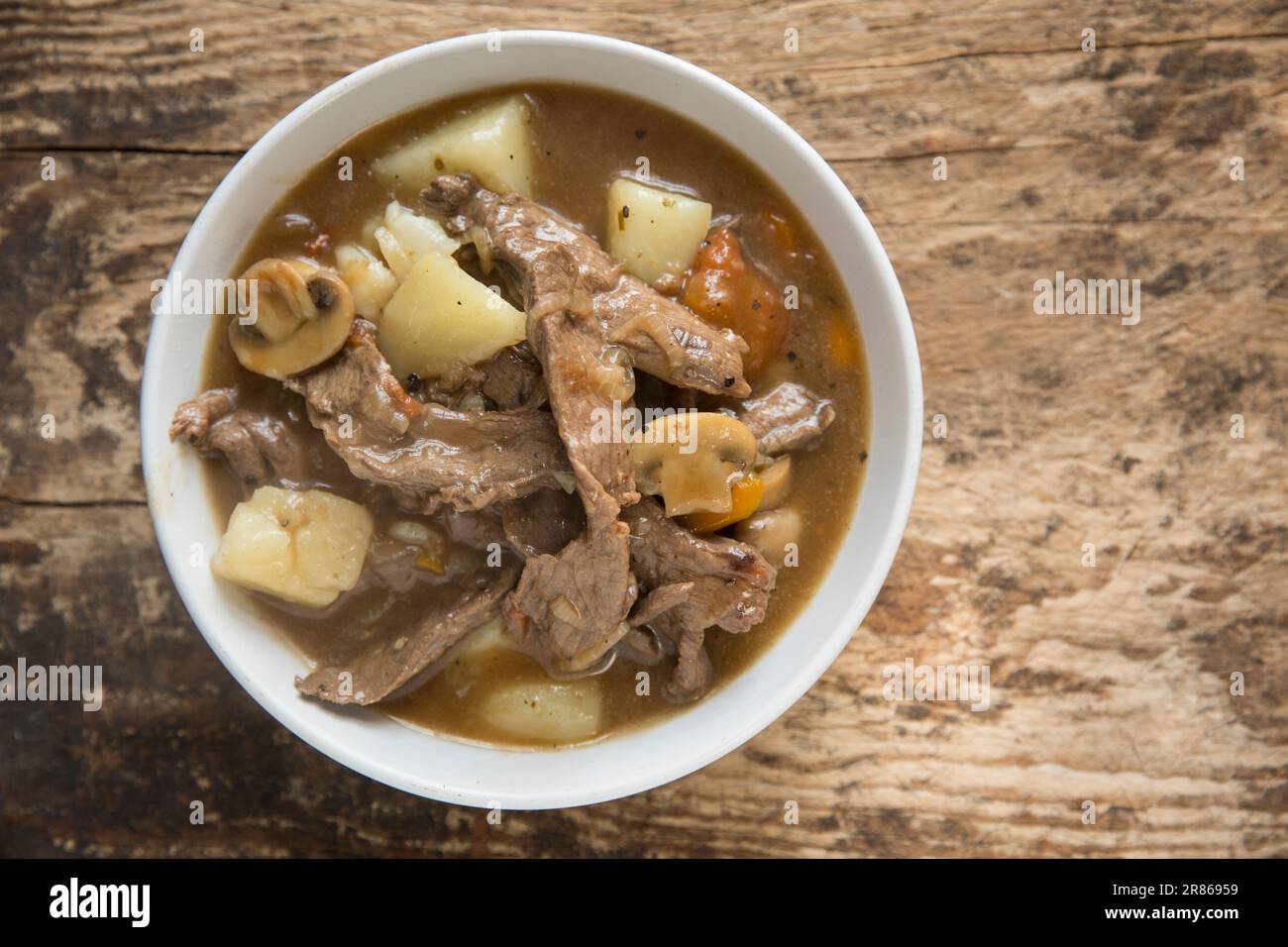 A homecooked stew made from venison from a roe deer, Capreolus capreolus, which includes onions, carrots and potatoes. England UK GB Stock Photo
