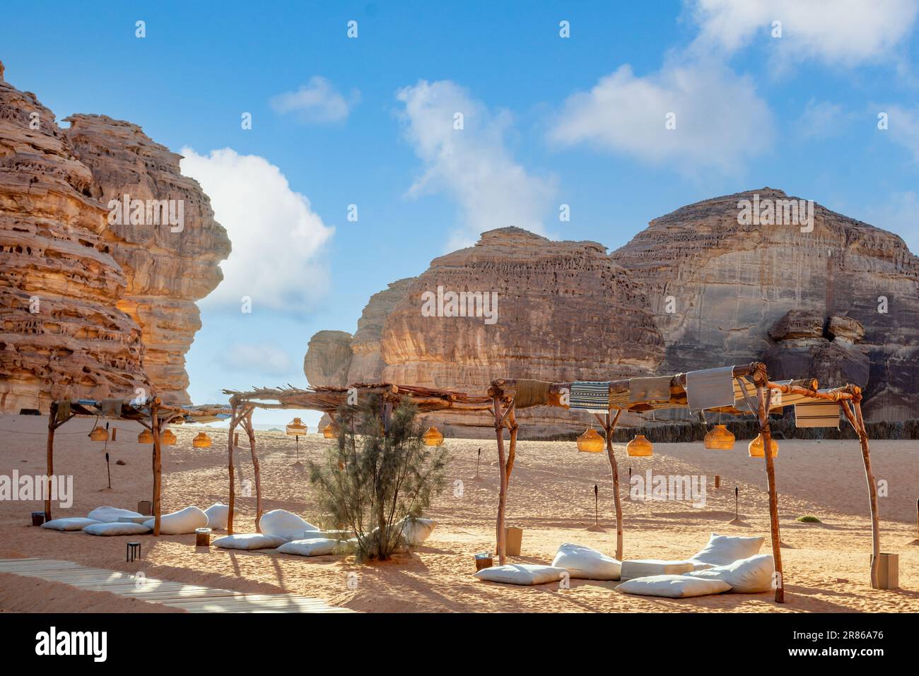 Outdoor lounge in front of elephant rock erosion monolith standing in the desert, Al Ula, Saudi Arabia Stock Photo