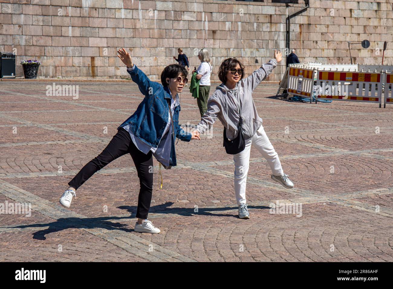 Asian tourists posing at Senate Square in Helsinki, Finland Stock Photo