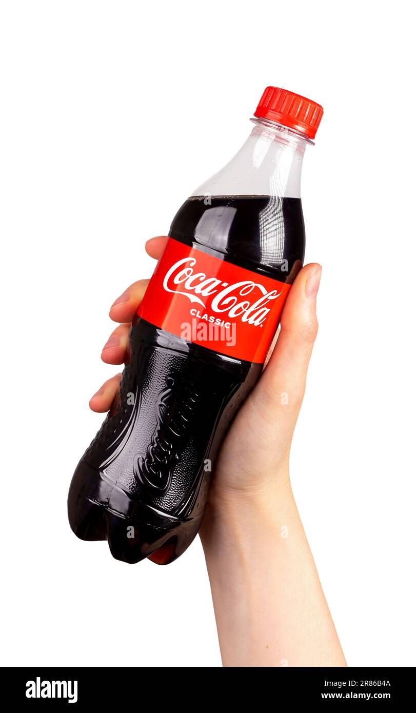 Coca Cola, plastic bottle in hand isolated on white background. Stock Photo