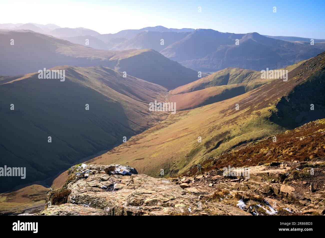The valley of Sail Beck below the summit of Knott Rigg and High Snockrigg with High Crag, High Stile and Red Pike in the distance in winter in the Eng Stock Photo