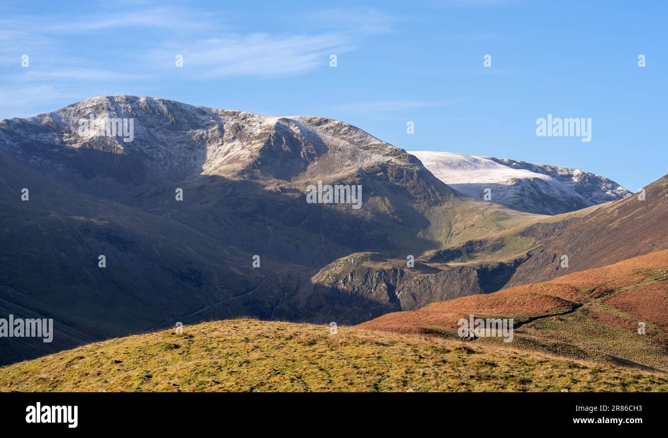 The summits of Crag Hill and Grasmoor above Force Crag from the trail leading to the summit of Grisedale Pike in winter in the English Lake District, Stock Photo