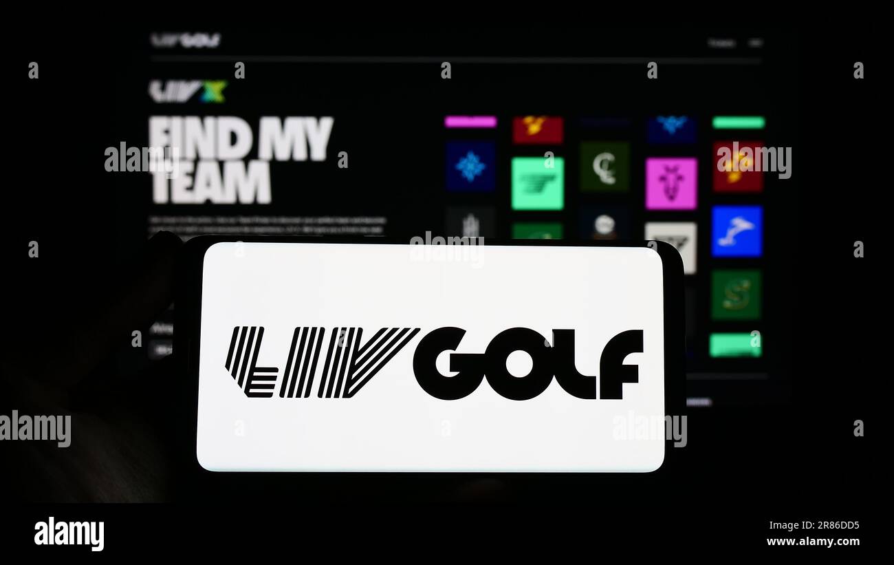 Person holding smartphone with logo of sports organization LIV Golf on screen in front of website. Focus on phone display. Stock Photo