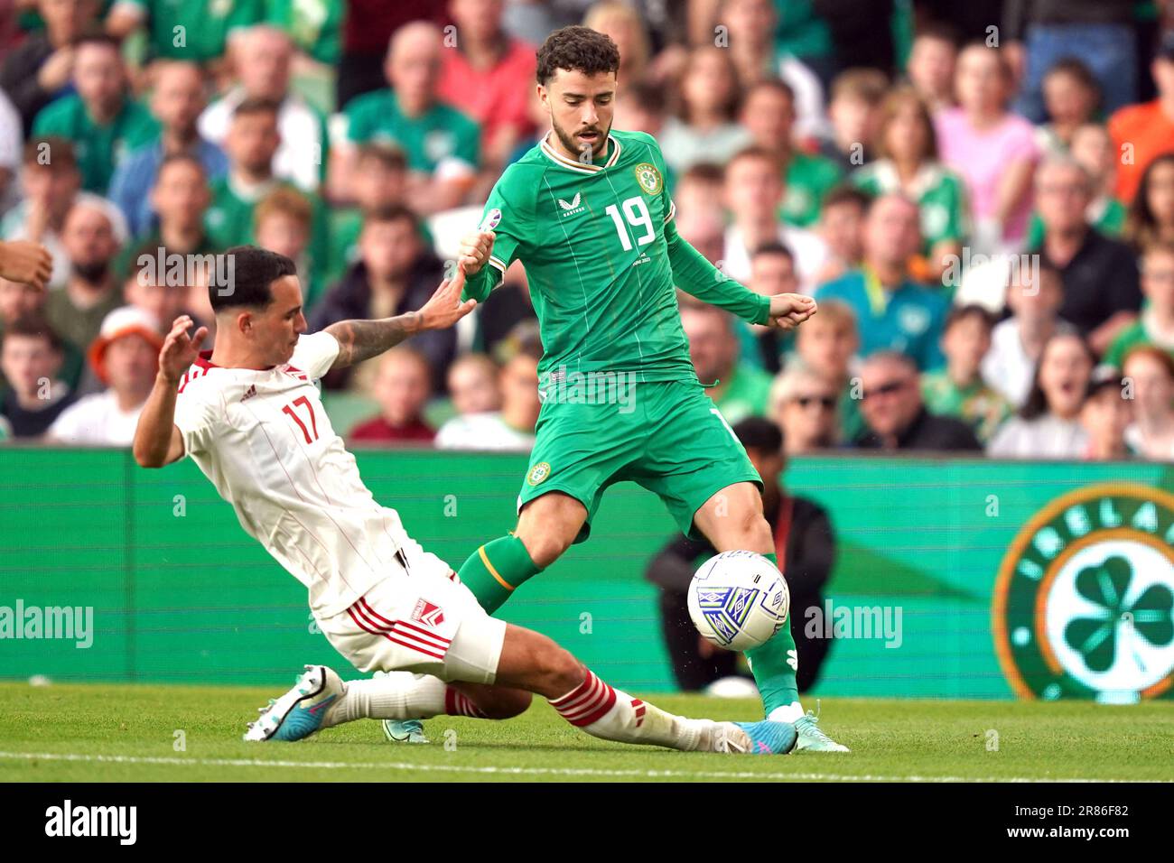 Republic of Ireland's Michael Johnston (right) and Gibraltar's Kian Ronan battle for the ball during the UEFA Euro 2024 Qualifying Group B match at the Aviva Stadium, Dublin. Picture date: Monday June 19, 2023. Stock Photo