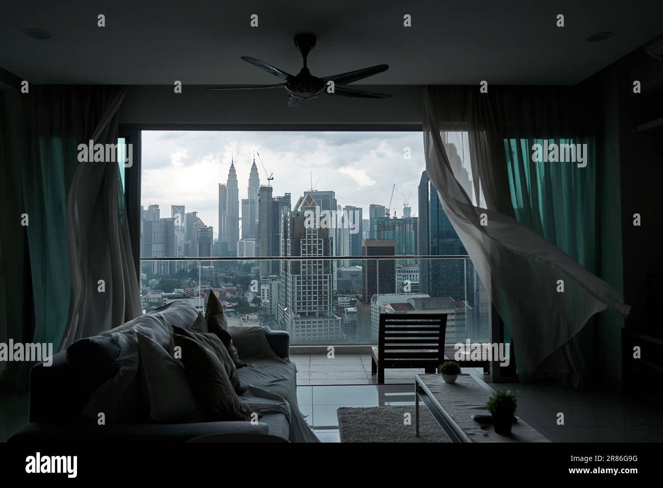The Wind Rustles The wind rustles the curtain of the panoramic window with a cityscape ...