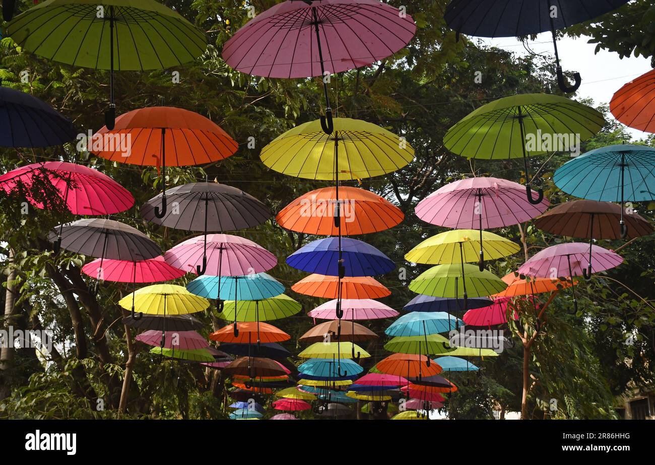 Mumbai, India. 19th June, 2023. Colourful umbrellas are seen hanging as an installation at an alley outside a playground in Mumbai. Umbrellas are hanged as a part of beautification plan ahead of the monsoon season. (Photo by Ashish Vaishnav/SOPA Images/Sipa USA) Credit: Sipa USA/Alamy Live News Stock Photo