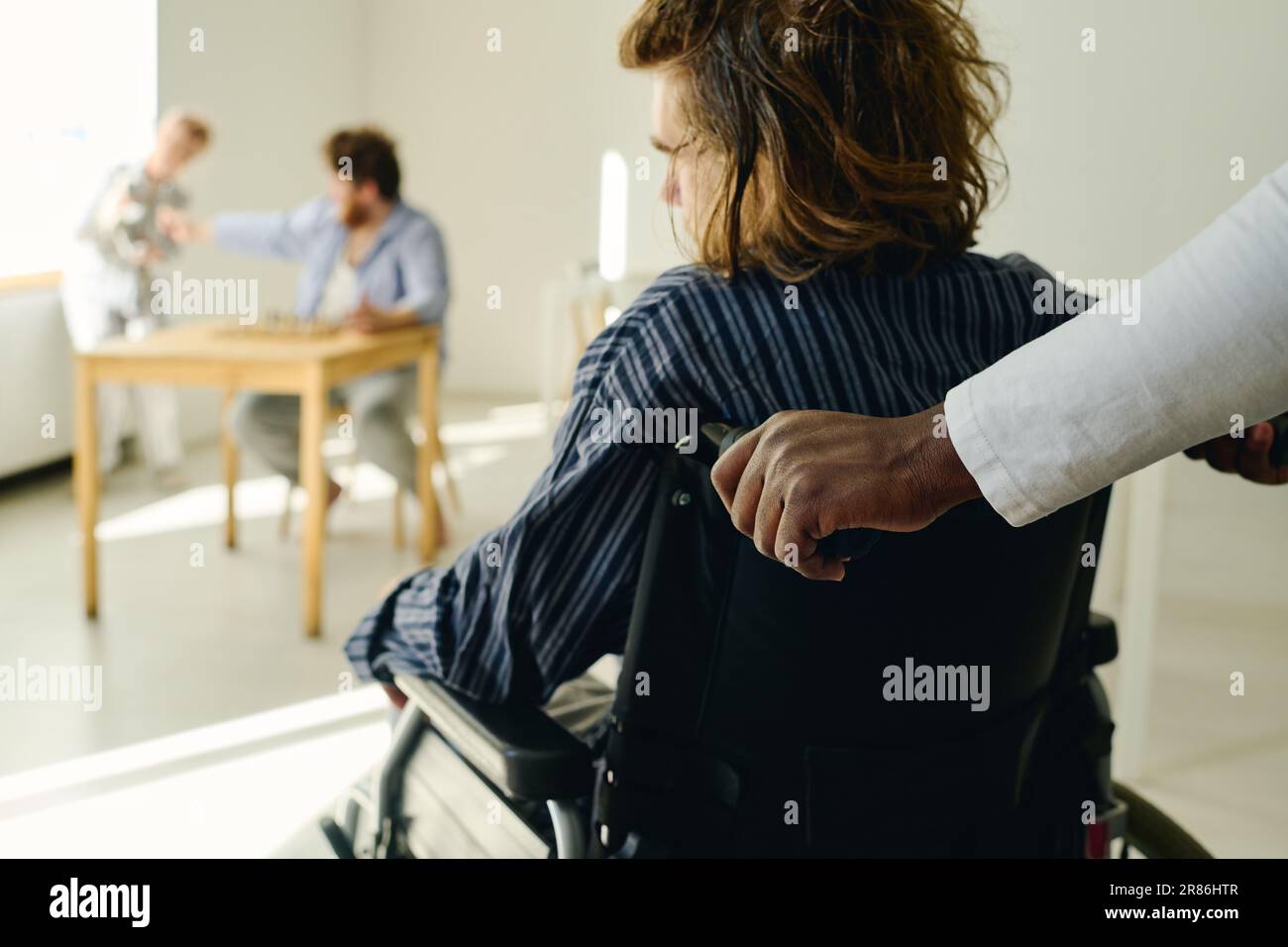 Rear view of patient of mental hospital with anxiety disorder sitting