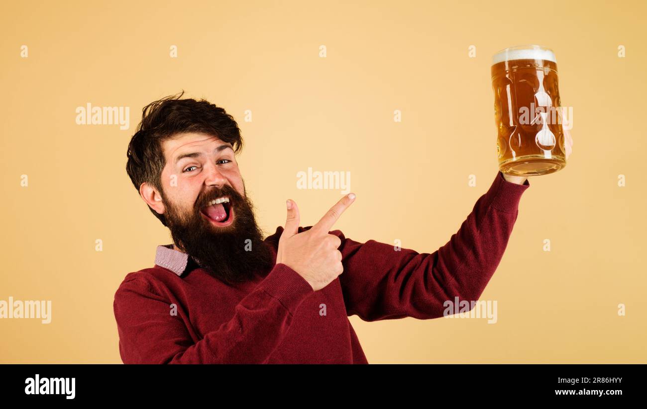 Beer pub. Beer time. Emotional bearded man pointing with finger at beer