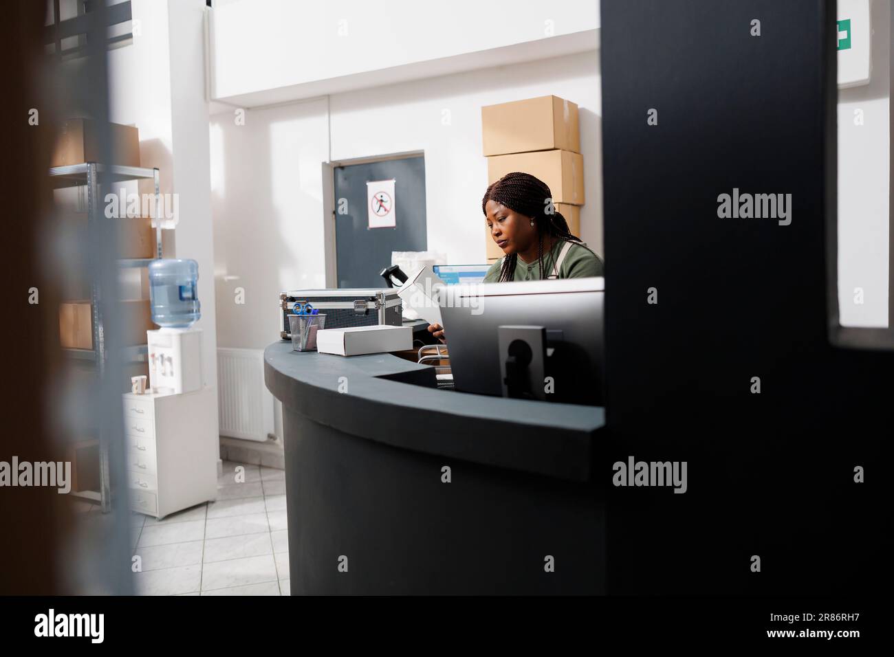 Merchandise Inventory Computer Storehouse employee analyzing cargo packages hi-res stock photography ...